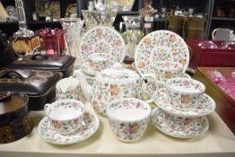 A Haddon Hall fine bone china tea service decorated with floral patterns on a white ground, to