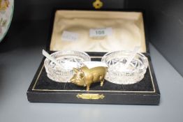 An early 20th century novelty brass dice case modelled in the form of a pig, L5cm, sold together