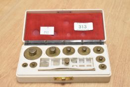 A box containing various brass weights