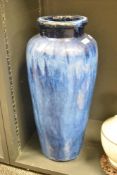 A large and heavy pottery vase of lobed form decorated in blue wash glaze, h57cm