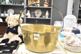 An early 20th century brass jam pan, w32cm, sold together with a brass ladel
