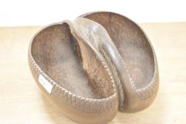 A vintage Coco de Mer, having simplistic carved decoration, modelled into trug/basket shape,