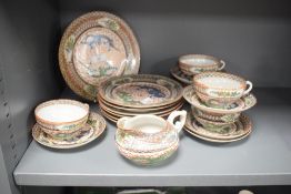 A Chinese ceramic tea service decorated with dragon patterns, comprising of 5 cups, 6 saucers, 6