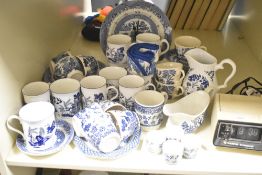 A ceramic tea service decorated in the Willow style, to include cups and sauce boat ect