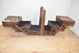 A carved wooden sewing box, closed L30cm