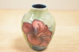 A Moorcroft pottery 'Hibiscus' pattern vase of lobed form, h9.5cm