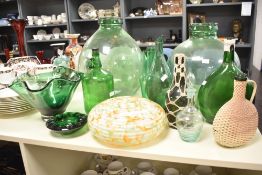 A quantity of green glass bottles, to include a glass pendant shade ect