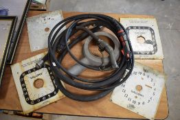 Four petrol pump clock faces, enamelled metal, and filler pipe