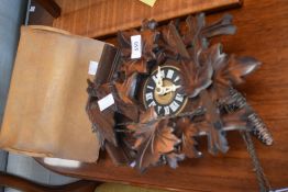 A vintage cuckoo clock and a leather stationery rack