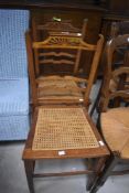 A pair of Edwardian oak cane seated bedroom chairs
