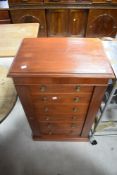 An interesting mahogany faux Wellington chest, the hinged door formed as a bank of lockable drawers,