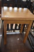 A modern golden oak occasional table, width approx. 40cm