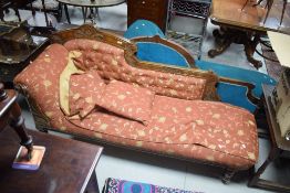 A late Victorian oak framed chaise longue, of traditional design with scrolled arm and buttoned