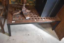 A stained frame coffee table, the top manufactured from a wooden screen