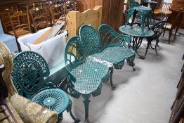 A vintage cast alloy garden set comprising settee, two chairs and circular bistro table