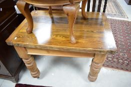 An early 20th century pine fold-over top table the shaped top with hinged and swivel action over
