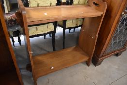 A golden oak Arts and Crafts style open bookshelf of small proportions