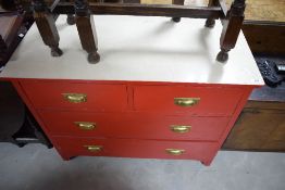 An early 20th century red painted pine chest of 2/2 drawers with attached formica top, 77cm x 96cm x
