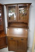 An Arts & Crafts mahogany bureau bookcase, the upper stage with leaded glass panels over the fall