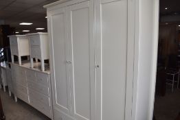 A modern MDF bedroom suite of nice quality, in white with glass handles, comprising triple wardrobe,