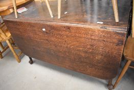 A 19th Century oak drop leaf table having shaped gateleg, approx width 149cm x d118cm x h71cm