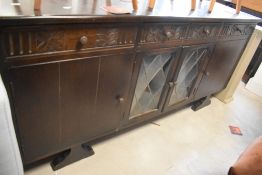 A vintage Old Charm style sideboard base having glazed section