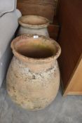 Two large clay planters , of bulbous form, height approx. 61cm, one with chip to rim