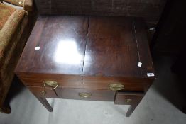 A 19th Century Regency design mahogany fold out washstand having mirror and compartmental