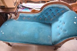 A late Victorian chaise longue, of typical form with scrolled arm and deep buttoned back 94cm x