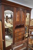 A Vicorian mahogany and walnut mirror door double wardrobe with central cupboard and drawer section