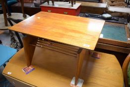 A 1950's modernist laminate coffee table the oblong top on metal supports over shaped legs linked by