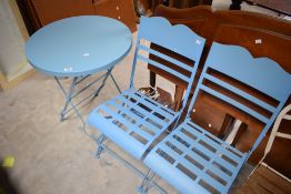 A blue painted circular metal folding garden table and two chairs, 75cm x 61cm & seat height 45cm