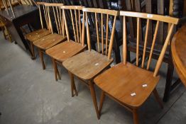 A set of seven vintage Ercol stick back chairs, possibly model 608, showing some wear and tear to