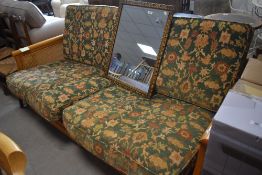 A modern Ercol Bergere style settee having light coloured frame and canework end panels with floral