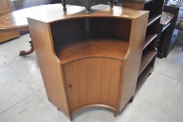A mid 20th Century walnut corner unit