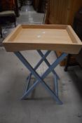 A modern folding side table with tray top (Butlers tray)