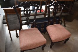 A pair of Victorian low seat nursing chairs having foliate backs and overstuffed seats