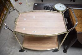 A mid century two tier tea trolley, of typical form 78cm x 79cm x 41.5cm