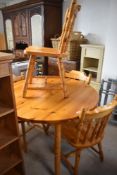 A vintage pine circular farmhouse kitchen style circular extending dining table and four chairs,