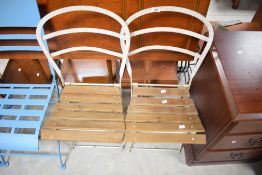 A pair of folding metal framed and slatted chairs, seat height 47.5cm