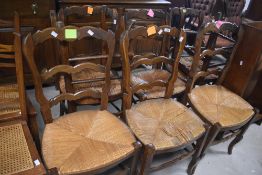 A set of eight rush seated chairs in the Flemish style having shaped ladder backs