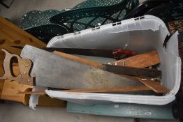 A selection of vintage tools including saws and planes