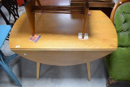 An unmarked but believed to be Ercol light elm drop-leaf dining table, of typical design 72cm x