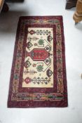 A small North West Persian Belouch type rug with fringed sides 115cm x 59cm