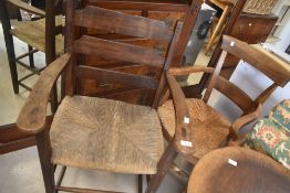 Two 19th Century rush seated carved cheers, one possibly being a correction chair