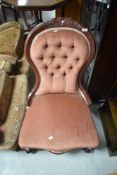 A Victorian mahogany framed nursing chair having later pink dralon upholstery