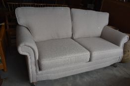 A modern two seater settee in nice clean condition with a neutral colour, width approx. 190cm