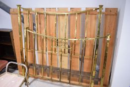 An early 20th century brass bedstead with bowed top rails and further square section rails, together