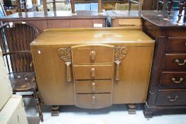 A mid 20th Century oak sideboard having four drawers to centre flanked by cupboards, width approx.