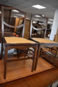 A pair of mahogany framed bedroom chairs having cane seats